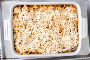 Step 8 how to make buffalo chicken casserole with cream cheese, Remove from the oven and remove the foil. Sprinkle cheese on top and continue to bake, uncovered.