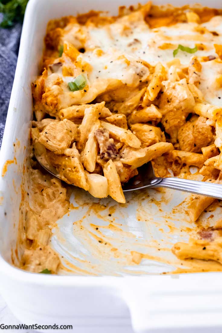 Our buffalo chicken casserole is perfect for those who enjoy buffalo wings with Ranch Dressing, offering a spicy and tangy flavor. #buffalochicken #chickencasserole scooped a portion of buffalo chicken casserole with pasta