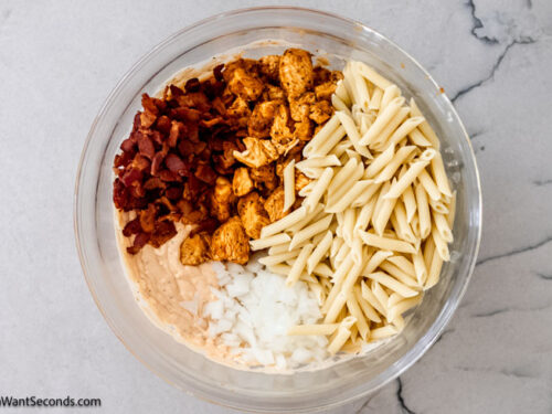 Step 4 how to make buffalo ranch chicken casserole, Add in the cooked chicken, cooked bacon, cooked pasta, and onion.