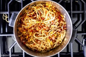 Step 5 how to make old fashioned cowboy spaghetti, Add the cooked bacon and toss to coat the pasta. Adjust the seasonings.