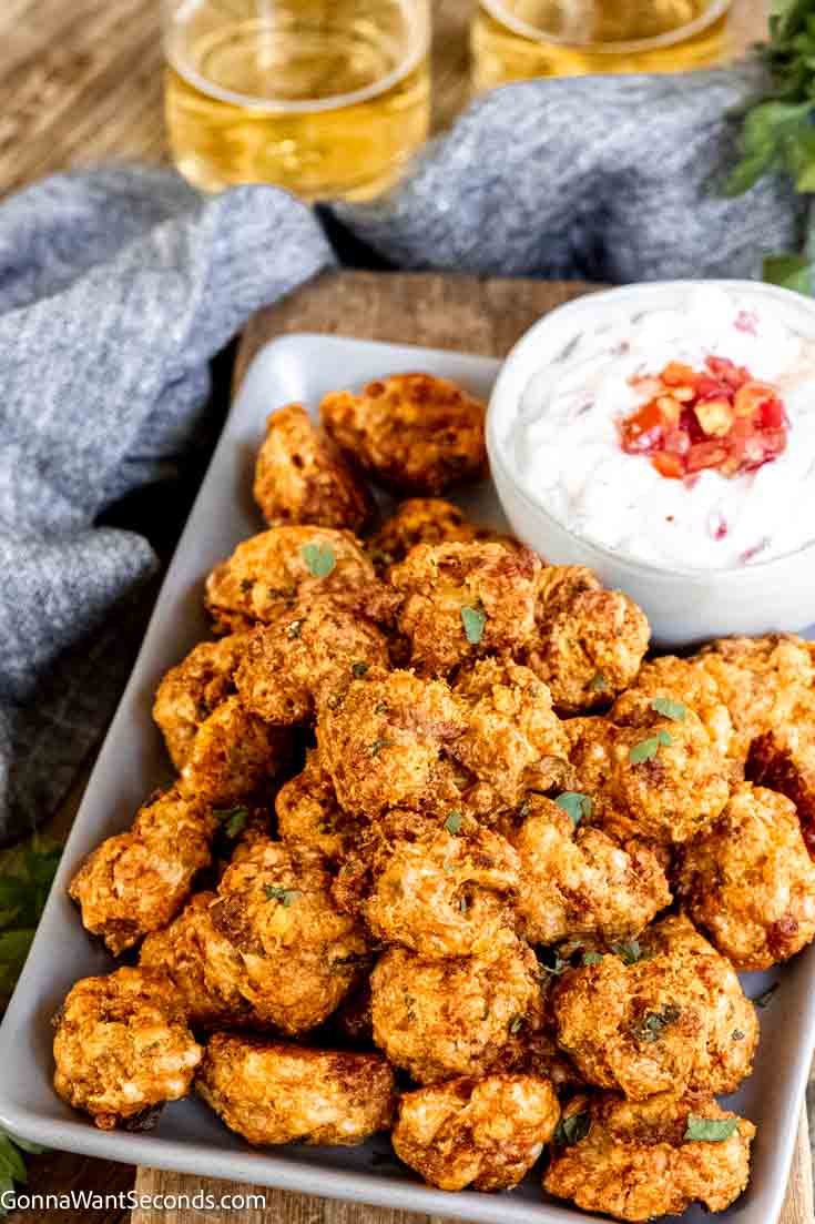 If you love sausage balls, you have to try our new Doritos sausage balls next! Sausage, nacho chips + Bisquick makes these perfectly delicious! #doritos #sausageballs Doritos sausage balls with sour cream-salsa dip on the side