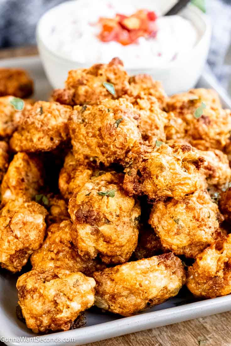 If you love sausage balls, you have to try our new Doritos sausage balls next! Sausage, nacho chips + Bisquick makes these perfectly delicious! #doritos #sausageballs Doritos sausage balls with sour cream-salsa dip on the side