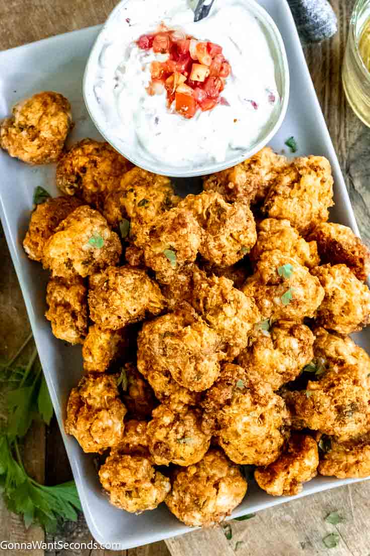 If you love sausage balls, you have to try our new Doritos sausage balls next! Sausage, nacho chips + Bisquick makes these perfectly delicious! #doritos #sausageballs Doritos sausage balls with sour cream-salsa dip on the side