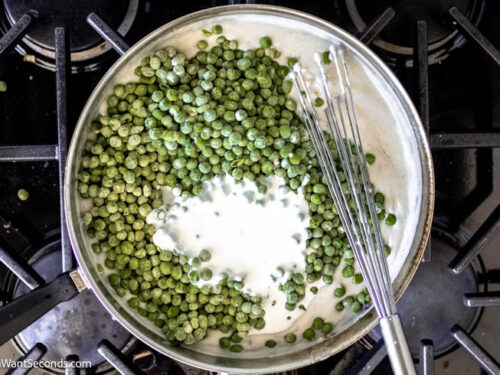Step 6 how to make creamed green peas, Stir in thawed peas and heavy cream.