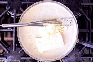 Step 6 how to make fresh creamed spinach, Add in the cream cheese and Parmesan.