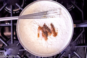 Step 7 how to make creamed spinach, Stir in nutmeg, allspice, cajun seasoning, salt and pepper.