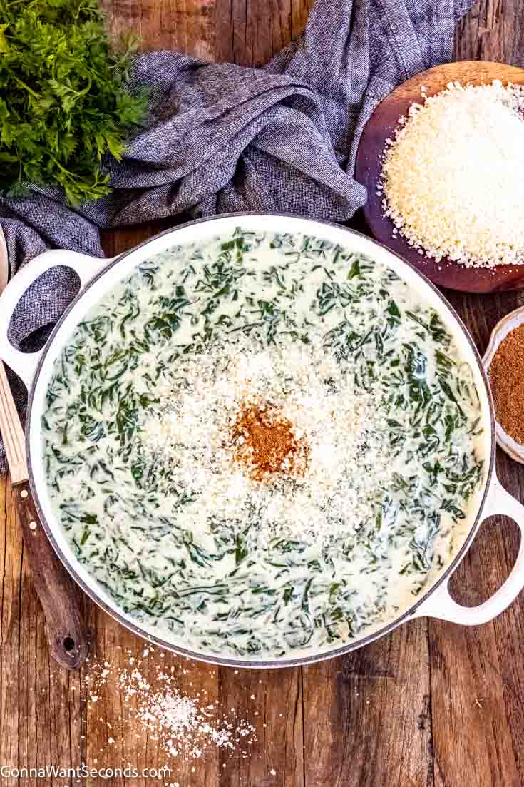 Creamed spinach is a classic dish that is often served with prime rib. This recipe is made with white sauce, nutty parmesan, aromatics, and lots of spinach! #creamedspinach #spinach creamed spinach with cream cheese top shot
