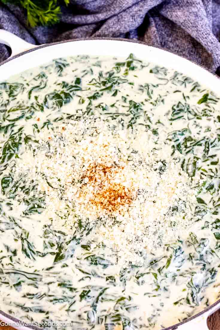 Creamed spinach is a classic dish that is often served with prime rib. This recipe is made with white sauce, nutty parmesan, aromatics, and lots of spinach! #creamedspinach #spinach fresh creamed spinach close up