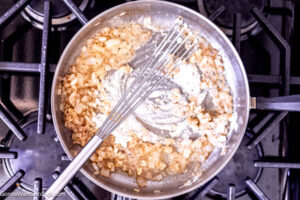Step 4 how to make creamed spinach, Sprinkle flour over cooked onion mixture, and whisk until a thick paste is formed.