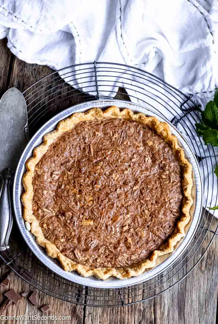 Rich and smooth, my fudge pie is simple to make and will knock your socks off! We deepen the chocolate filling with a little espresso powder and add pecans. #fudgepie #chocolatepie whole fudge pie with pecans top shot