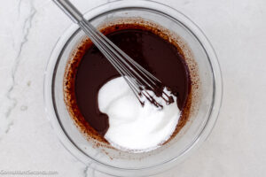 Step 2 how to make fudge pie with pecans, Add sugar and flour to chocolate mixture and whisk.