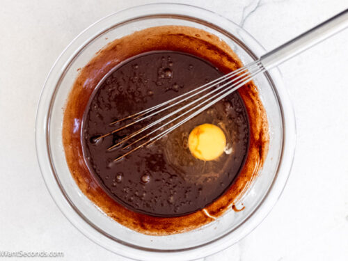 Step 3 how to make chocolate fudge pie, Add eggs to the mixture, one at a time. Whisk.