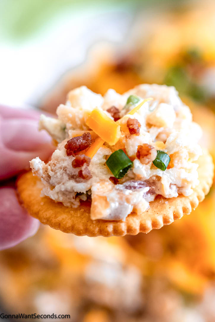 million dollar dip with cream cheese spread on top of a Ritz cracker