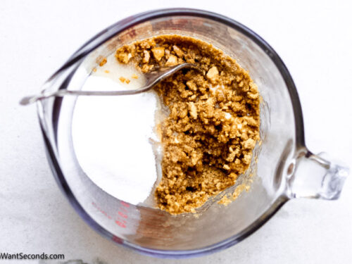 Step 1 how to make pumpkin cheesecake, Make the crust: Combine gingersnap crumbs, melted butter, and sugar.