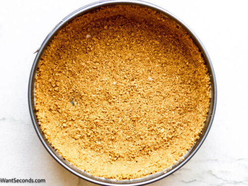 Step 4 how to make pumpkin pie cheesecake, Transfer crumb mixture to prepared springform pan and press crumbs on the bottom and up the sides. Bake.