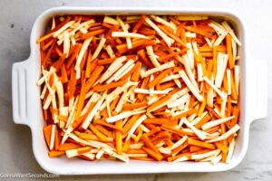 Step 3 how to make roasted carrots and parsnips, Spread the mixture in the baking dish. Roast in the oven.
