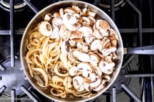 Step 6 how to make salisbury steak with onion gravy, Cook the onions and add the mushrooms.