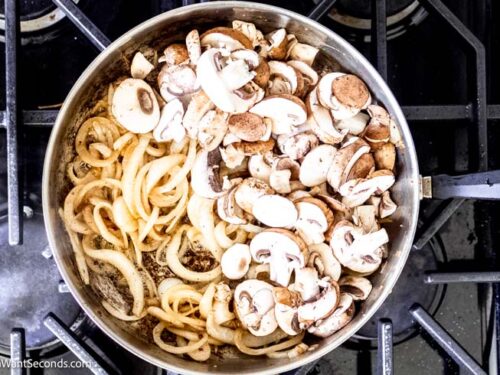 Step 6 how to make salisbury steak with onion gravy, Cook the onions and add the mushrooms.
