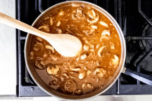 Step 7 how to make salisbury steak sauce, Make the gravy. Stir in the tomato paste, and sprinkle it with flour. Stir in the beef broth, dissolved bouillon, and sherry. Simmer.