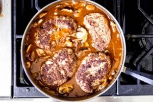 Step 8 how to make salisbury steak, Nestled the meat patties into the sauce. Cover and continue to cook.