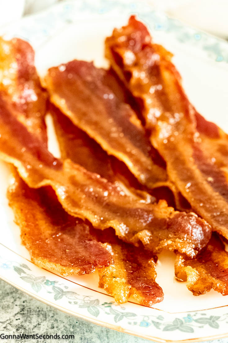 Million dollar bacon is a sweet and spicy strip of crispy heaven, with its candy coating on smoky bacon, making it an irresistible, finger-licking treat. #bacon #milliondollarbacon Million dollar bacon on a plate