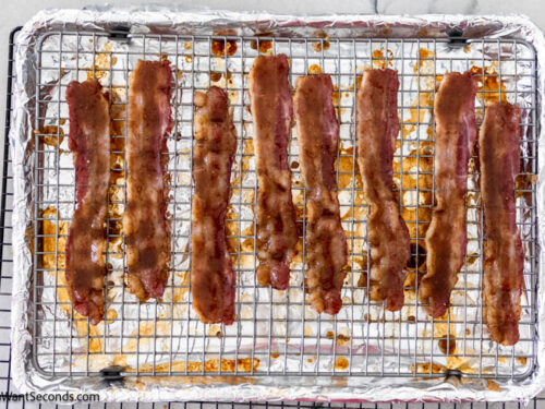 Step 5 how to make million dollar bacon, Dip bacon slices in sugar mixture, coating evenly on both sides. Return to the oven and bake.