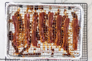 Step 6 how to make million dollar bacon, Remove baking sheet from oven again and sprinkle remaining brown sugar over slices. Bake again.