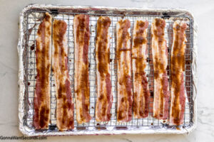 Step 4 how to make million dollar bacon, Arrange bacon slices on the wire rack. Bake and remove from the oven.