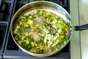 Step 2 how to make pepperoni pizza casserole, Saute the onions and bell pepper. Add the herbs, seasonings, and spices.