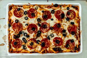 Step 5 how to make pizza casserole, Remove from oven and discard foil. Sprinkle mozzarella evenly over top of casserole. Return to oven and bake, uncovered.