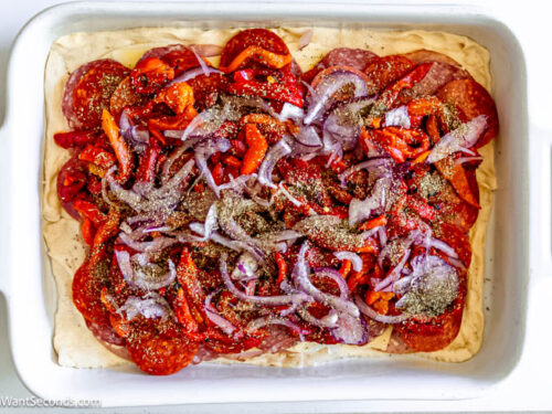 Step 9 how to make antipasto squares, Sprinkle Italian seasoning. Pour 3/4 of the egg mixture over the layered meats and cheeses.