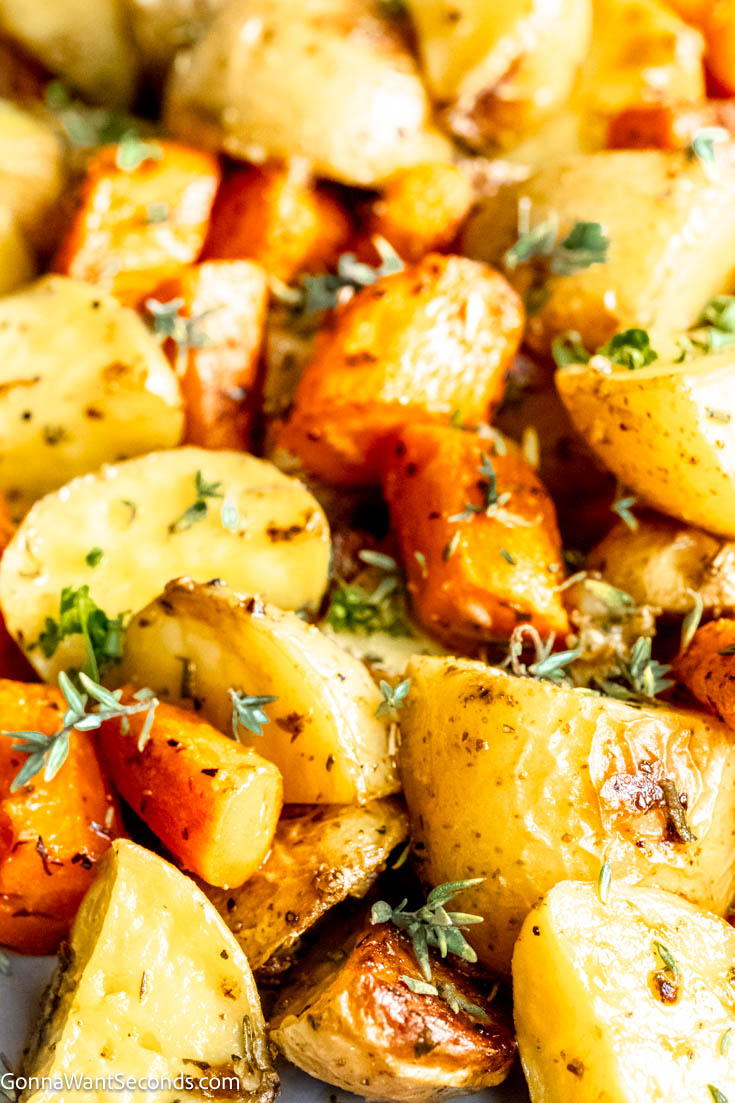 Our roasted potatoes and carrots are tossed with garlic herb butter and roasted to perfection. It's a wonderful side dish that pairs well with almost anything. #roastedcarrots #roastedpotatoes Roasted Potatoes and Carrots close up
