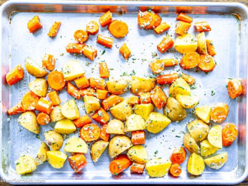 Step 3 how to make roasted potatoes and carrots, Add potatoes and carrots. Toss to evenly coat the veggies.Transfer vegetables to the baking sheet.