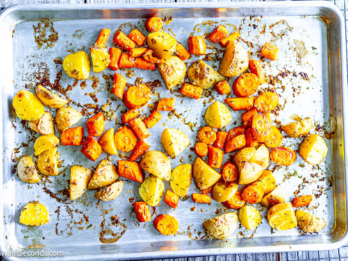 Step 4 how to make roasted potatoes and carrots, Bake.