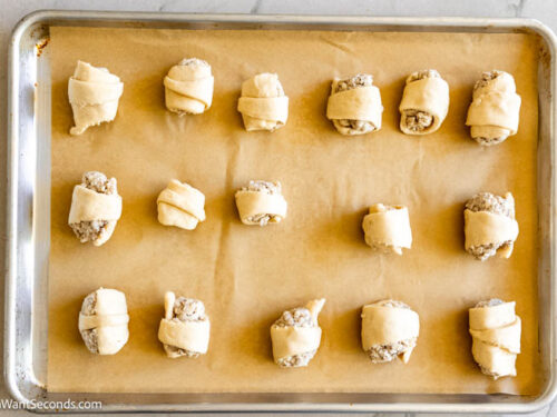 Step 6 how to make Sausage Cream Cheese Crescents, Place a dollop of the sausage mixture at the wide end of the triangles. Roll up the crescents.