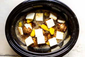 Step 8 how to make Mississippi pot roast meatballs, Arrange butter slices and pepperoncini peppers over meatballs. Cover and cook on low.