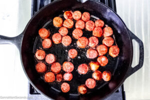 Step 7 how to make pinto bean and ham hock soup, In a skillet brown the sliced sausage. Transfer the sausage to soup pot.