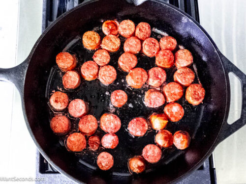 Step 7 how to make pinto bean and ham hock soup, In a skillet brown the sliced sausage. Transfer the sausage to soup pot.