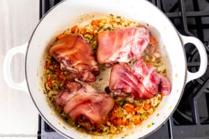 Step 4 how to make pinto bean soup with ham hocks, Add the ham hocks and water and boil.