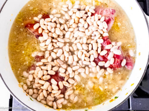 Step 5 how to make pinto bean soup, Add drained beans, Cajun seasoning, and bay leaves.
