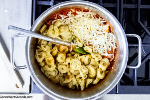 Step 3 how to make tortellini casserole with frozen tortellini, Add the marinara sauce, herbs, cream cheese, heavy cream, and mozzarella. Heat until the cream cheese is melted. Add the cooked tortellini. Mix.