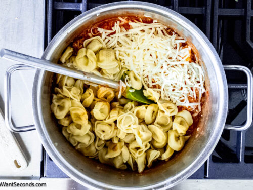 Step 3 how to make tortellini casserole with frozen tortellini, Add the marinara sauce, herbs, cream cheese, heavy cream, and mozzarella. Heat until the cream cheese is melted. Add the cooked tortellini. Mix.