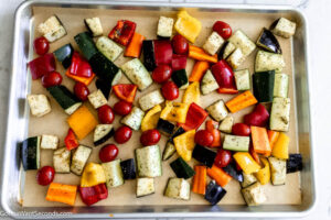 Step 5 how to make Mediterranean vegetables, Spread the vegetables on the sheet pan. Season with salt and pepper. Roast.