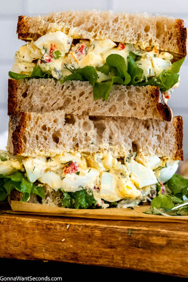 My creamy southern egg salad recipe is a riff on the classic version. I add a little spice using Creole mustard and Cajun seasoning, fresh dill, and cornichons. #eggsalad #eggs egg salad in a sandwich