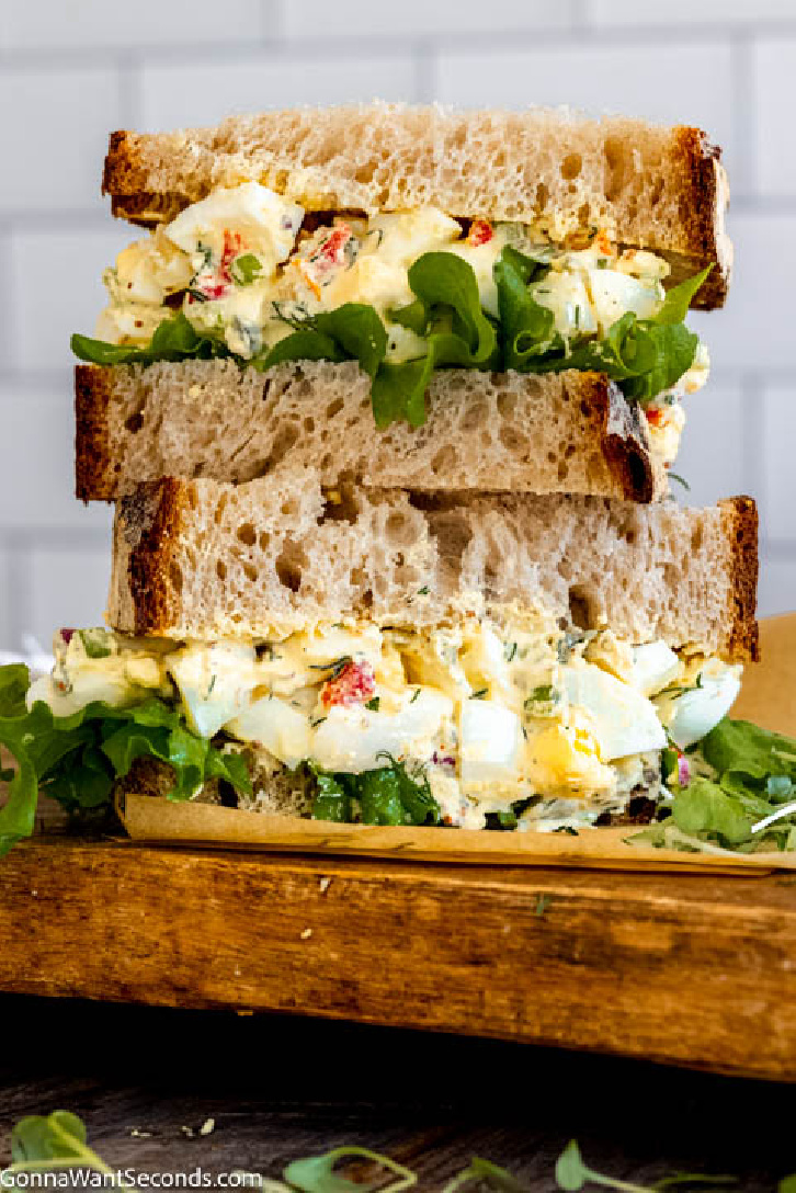 My creamy southern egg salad recipe is a riff on the classic version. I add a little spice using Creole mustard and Cajun seasoning, fresh dill, and cornichons. #eggsalad #eggs southern egg salad in a sandwich
