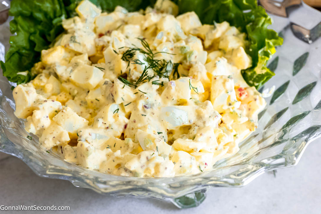 My creamy southern egg salad recipe is a riff on the classic version. I add a little spice using Creole mustard and Cajun seasoning, fresh dill, and cornichons. #eggsalad #eggs creamy southern egg salad in a bowl