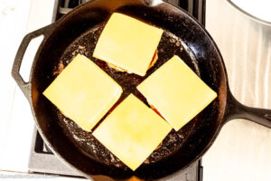 Step 6 how to make chicken burgers, If using cheese, top with cheese. Continue to cook patties.