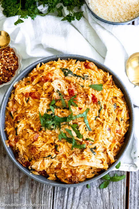 Marry me chicken orzo is packed with bursts of flavor like sundried tomatoes, garlic, parmesan, and fresh basil. It's a one-pan 30-minute meal! #marrymechicken #chickenorzo marry me chicken orzo in a bowl