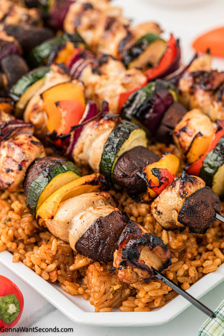 My go-to recipe in the summer is grilled chicken kebabs. Its marinade, with the powerful punch of Worcestershire sauce, adds great flavor to the chicken. #chickenkebabs #kebabs grilled chicken kebabs on top of rice