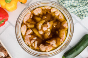 Step 2 how to make grilled chicken kabobs, Add the chicken pieces to the marinade mix. Refrigerate.